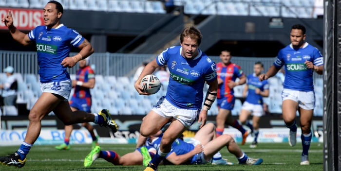 Newtown Jets halfback Todd Murphy runs in to score as his team-mate Kurt Kara salutes the moment at Remondis Stadium on Saturday. Photo: Michael Magee Photography.
