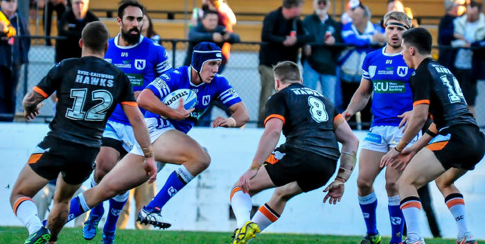 Young Newtown Jets front-rower Harrison Muller charges into the Wests Tigers defence at Leichhardt Oval on Saturday, with his team-mates Travis Robinson (left) and Matt McIlwrick close by. Photo: Gary Sutherland Photography.

