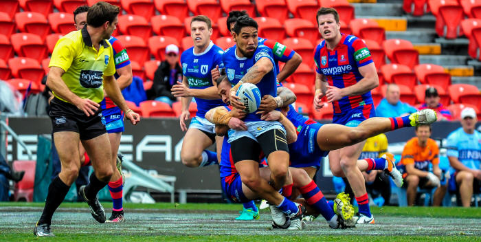 Newtown Jets hard-working front-rower Jesse Sene-Lefao looks to get away a clever off-load against the Newcastle Knights at Hunter Stadium on Saturday. Jets winger Jacob Gagan is in the background. Photo: Gary Sutherland Photography
