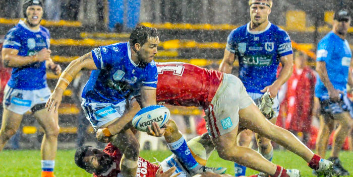 Just in case you weren’t aware – there was some heavy rain at Leichhardt Oval on Sunday night. Newtown’s hard-working forward Jason Schirnack is tackled by two Illawarra Cutters opponents, with team-mates Josh Cleeland (left) and Matt McIlwrick in close proximity. Photo: Gary Sutherland Photography