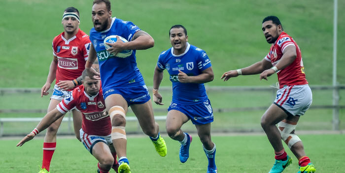 Giant Samoan international prop Sam Tagataese breaks through for the Jets against Illawarra on Saturday, with Newtown five-eighth Penani Manumalealii looming up in support. Photo: Gary Sutherland Photography
