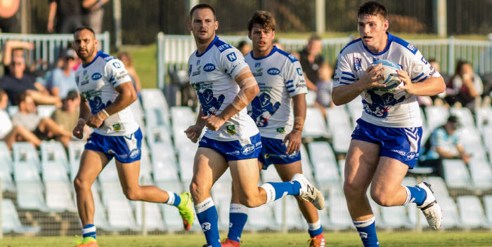 Young Newtown Jets front-rower Royce Tout takes the ball forward in last Saturday’s trial game against Blacktown Workers.
Royce is a product of the Gundagai Tigers RLFC and Wests Tigers Holden Cup (under 20’s). He is studying Law at Macquarie University and was chosen in the 2017 NYC Academic Team of the Year.
Other Jets players in the photo from left to right are: winger Jordan Topai-Aveai, fullback Matt Evans and lock Jayden McDonogh. Photo: MAF Photography (Mario Facchini)
