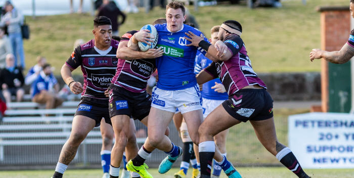 Newtown Jets front-rower Jimmy Jolliffe tries to burst through a wall of Blacktown Workers defenders at Henson Park on Saturday. Photo: Mario Facchini, mafphotography
