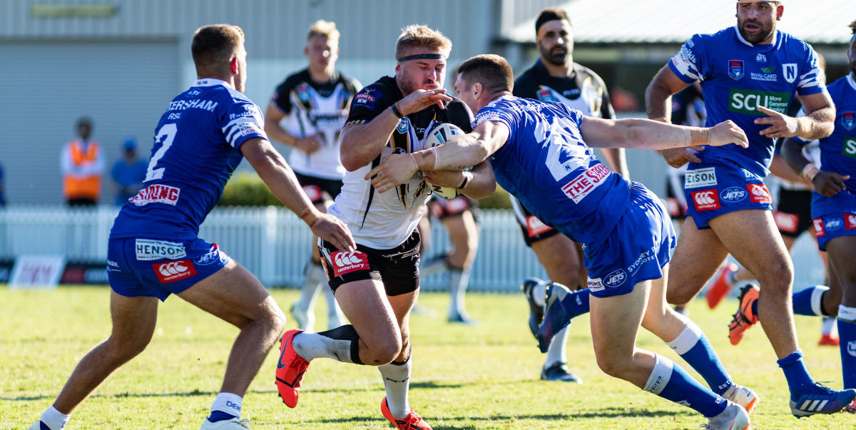 Newtown players Luke Polselli (number 2) and Josh Carr (number 20) move in on former Jets hooker Matt McIlwrick at Ringrose Park last Sunday. Newtown backrower Anthony Moraitis is on the right of the picture. Photo: Mario Facchini, mafphotography