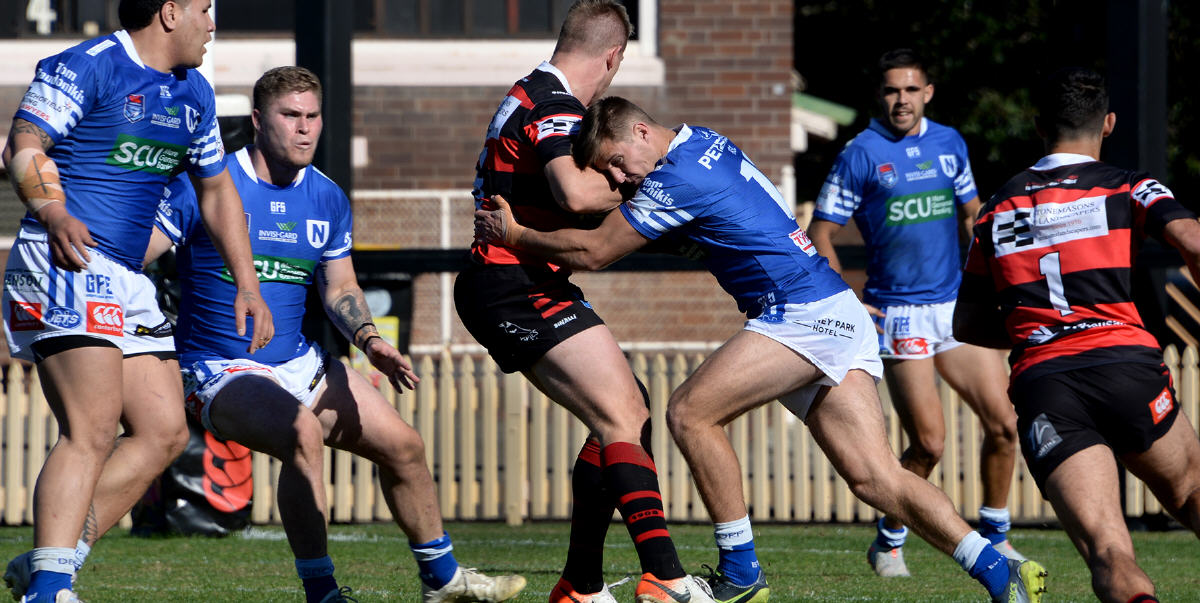 Newtown Jets second-rower Teig Wilton bails up a North Sydney Bears opponent in the Canterbury Cup NSW match played at North Sydney Oval last Sunday. Photo: Michael Magee Photography.