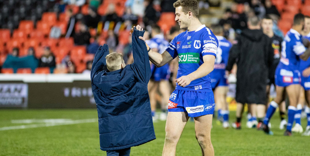 Newtown utility back Luke Polselli high-fives one of the Jets’ ball-boys at Panthers Stadium last Friday night – and that particular ball-boy just happens to be Praise Eastwood, son of Newtown Jets and Kiwi international front-rower Greg Eastwood. Photo: Mario Facchini, mafphotography