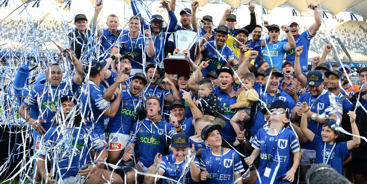 Jack A. Williams holds the Canterbury Cup NSW premiership trophy aloft in a moment of supreme triumph for the entire Newtown RLFC. Photo: Mike Magee Photography