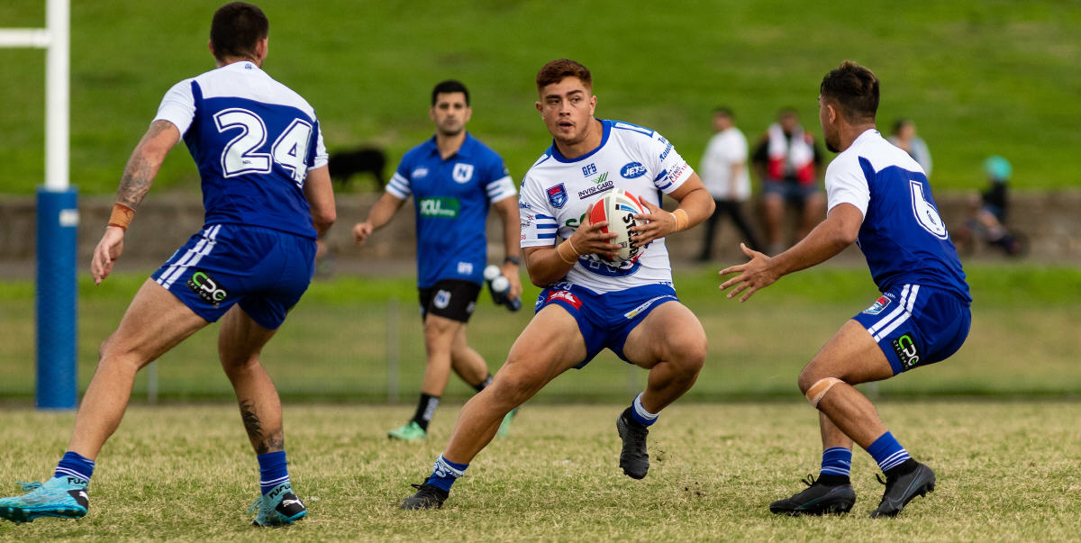 Newtown Jets outside back Jonah Ngaronoa puts a step on two Canterbury-Bankstown Bulldogs opponents at Henson Park on Saturday evening. Photo: Mario Facchini, mafphotography
