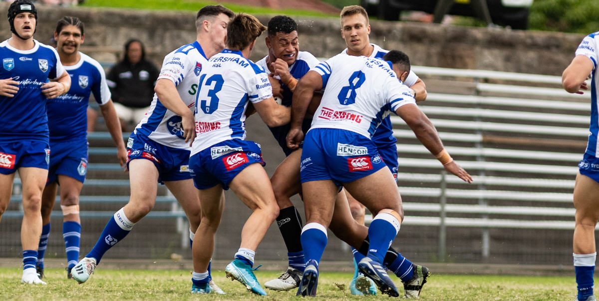 This Canterbury Bulldogs player is going nowhere as he runs into a trio of Newtown Jets defenders at Henson Park last Sunday (from the left: Matt Stimson, Jackson Stewart and Sione Afemui). Photo: Mario Facchini, mafphotography