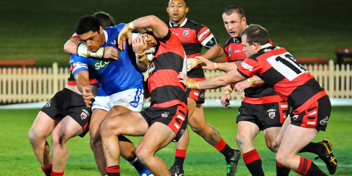 Newtown Jets front-rower Saulala Houma attempts to break through this sleuth of North Sydney Bears defenders in the exciting NSW Cup match played at North Sydney Oval on the night of Friday, 10th August 2012. Photo: Gary Sutherland Photography