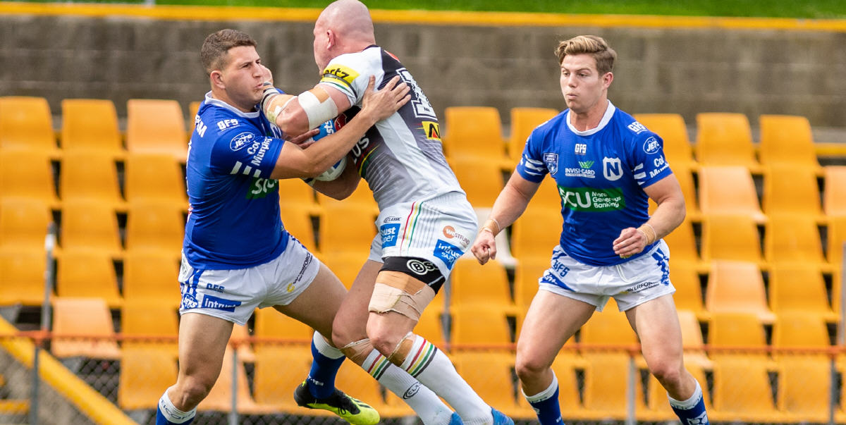 Gigantic Penrith Panthers prop Andy Saunders can’t get past Newtown Jets defenders Billy Magoulias (left) and Blayke Brailey at Leichhardt Oval on Saturday afternoon. Photo: Mario Facchini, mafphotography