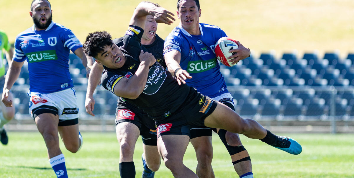 Newtown Jets centre Jackson Ferris dishes out a definitive “don’t argue” to an unfortunate Mounties opponent in Saturday’s Canterbury Cup elimination final played at Campbelltown Stadium. Photo: Mario Facchini, mafphotography