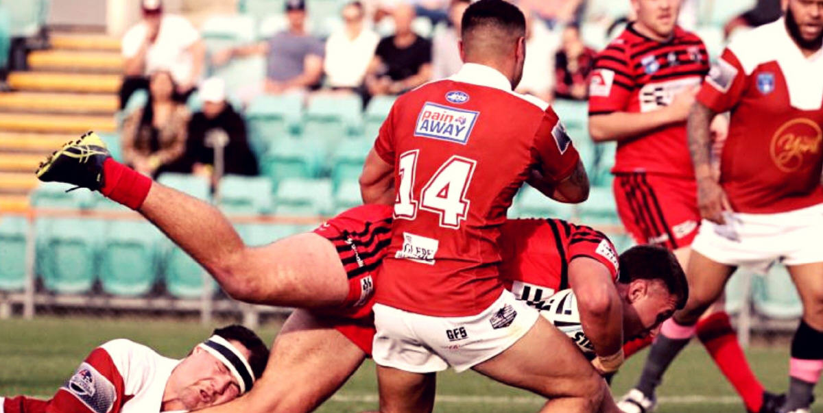 Glebe Dirty Reds players (from left) Thomas Hazelton, Trent Toelau and Kem Seru bring this North Sydney ball-carrier to an abrupt halt in the NSWRL President’s Cup grand final qualifier played at Leichhardt Oval on Saturday. Photo: Courtesy of the North Sydney RLFC.