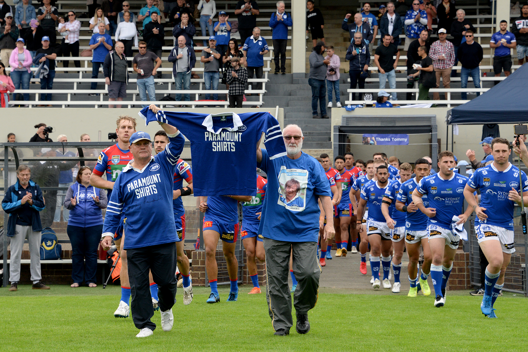 Two outstanding identities with many years of association with the Newtown RLFC, Colin Murphy (left) and Johnny Lewis, lead the teams out at Henson Park on Saturday while carrying a number seven jersey in honour of the late Tom Raudonikis.

 

Photo:
Michael Magee Photography.