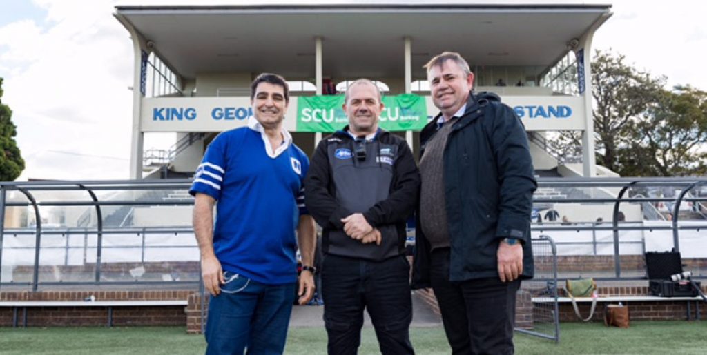 Councillor Victor Macri, Newtown Jets head coach Greg Matterson and Councillor Mark Drury inspect the Henson Park pitch prior to announcing Inner West Council funding for upgrading the Henson Park playing surface.