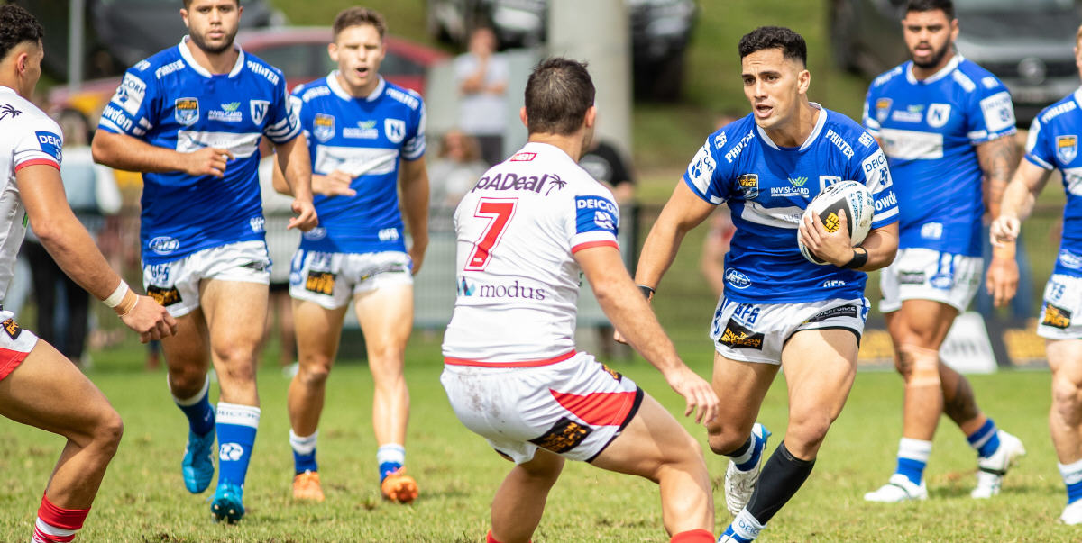 Newtown centre Kayal Iro (son of the legendary New Zealand Kiwis Test centre Kevin Iro) has these two St George-Illawarra defenders mesmerised. Photo: Mario Facchini/mafphotography