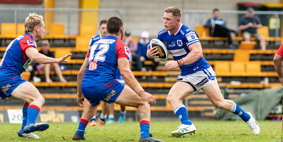 Newtown Jets back-rower Jack Williams takes on two Novocastrian defenders. Photo: Mario Facchini/mafphotography