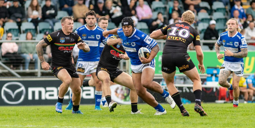 The splendid Franklin Pele bursts through the Penrith defensive line, with team-mates (from the left) Tyler Slade, Kade Dykes and Jayden Berrell in the background. Photo: Mario Facchini/mafphotography