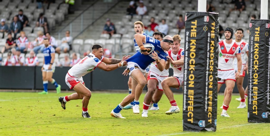 Newtown Jets front-rower Tommy Hazelton rips through the Dragons defence to score his second try on Sunday. Photo: Mario Facchini/mafphotography