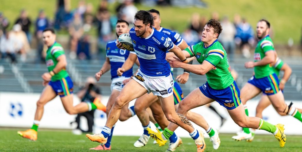 Newtown centre Mawene Hiroti breaks clear of these Canberra Raiders defenders. Photo: Mario Facchini/mafphotography
