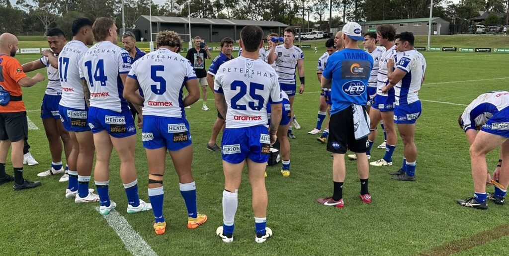 Newtown RLFC Assistant Coach Tony Barnes talks with the Jets players at the first break during Saturday's trial match at the Morry Breen Field, Wyong. Photo: Steven Russo