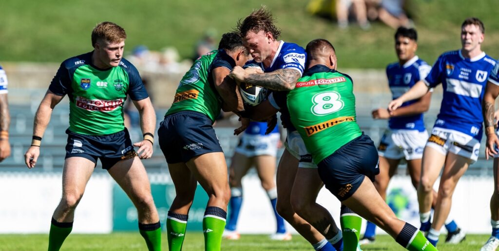 The Newtown Jets middle forward Max Bradbury heads straight into the furnace of the Canberra Raiders forwards' defence. Photo: Mario Facchini/mafphotography