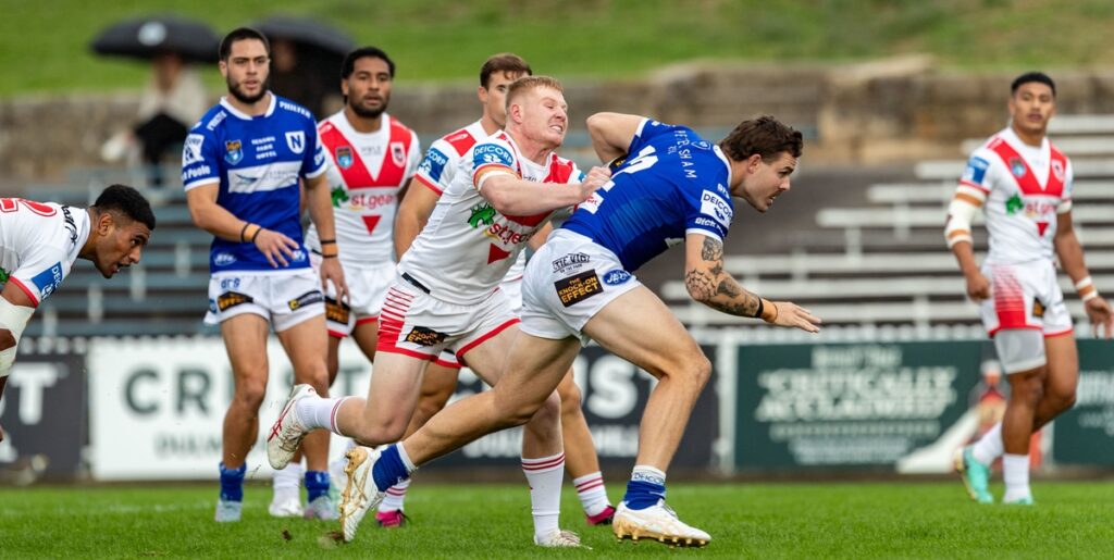 Newtown Jets back-rower Billy Burns bursts through the Dragons defence on Saturday. Jets centre and goal-kicker Mawene Hiroti is at the left of the photo. Photo: Mario Facchini, mafphotography)
